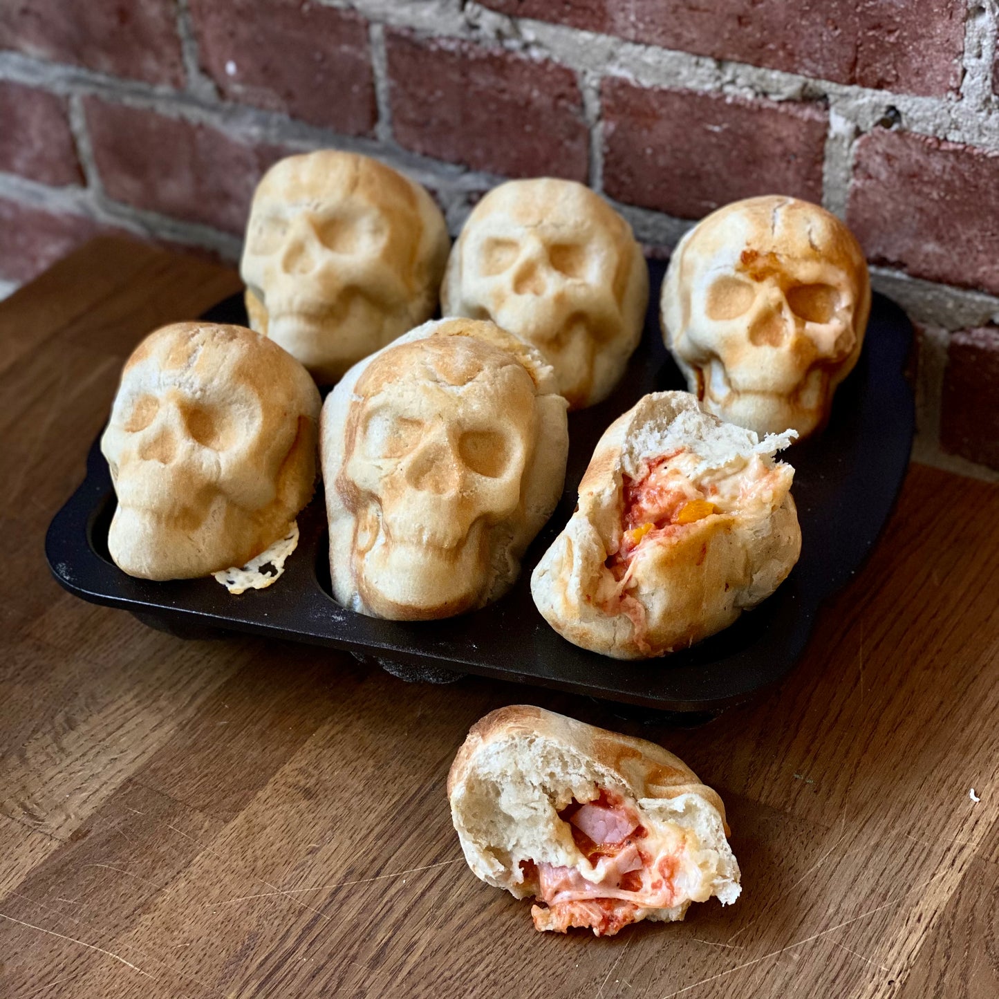 Skull shaped pizzas with marinara sauce dip