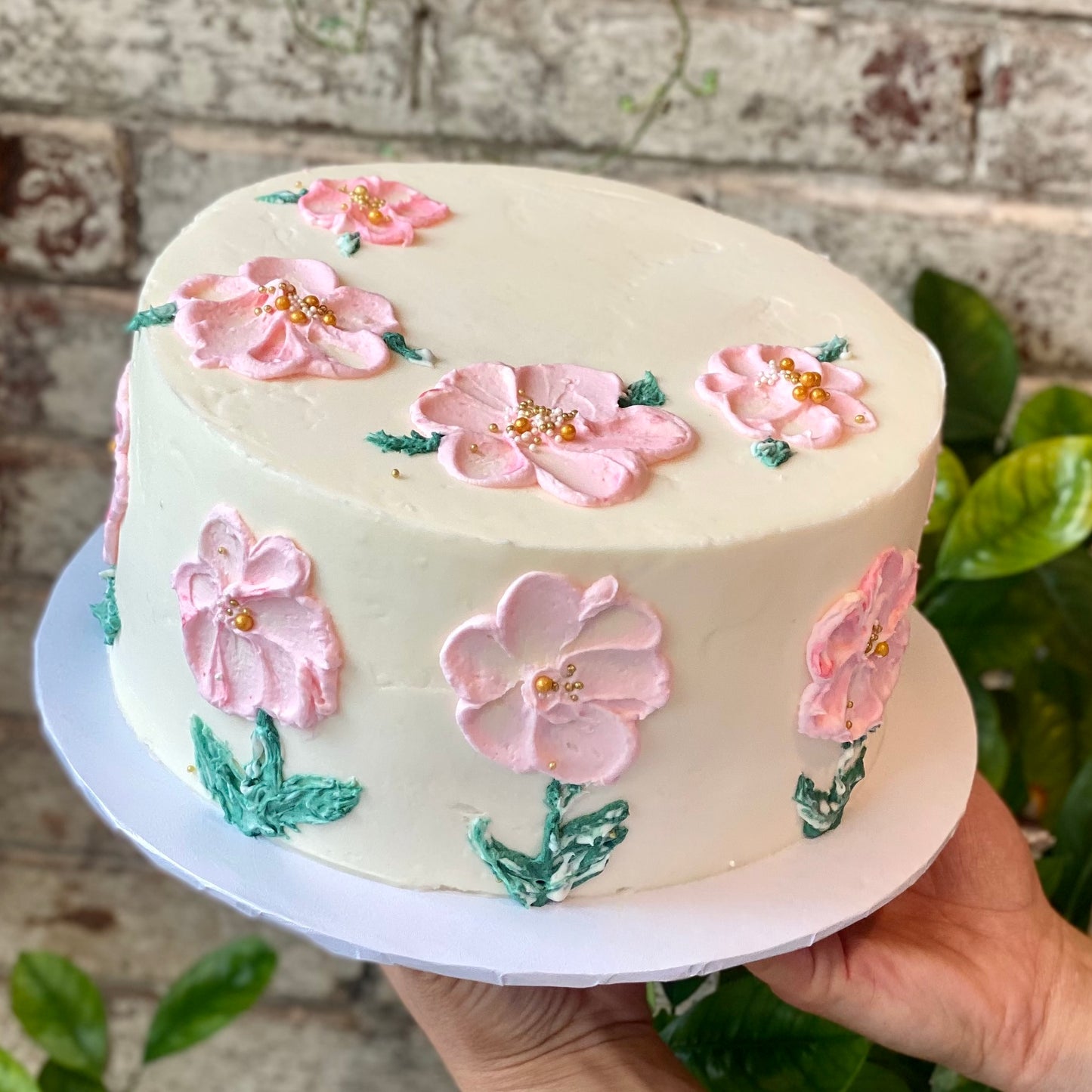 White cake with pink flowers