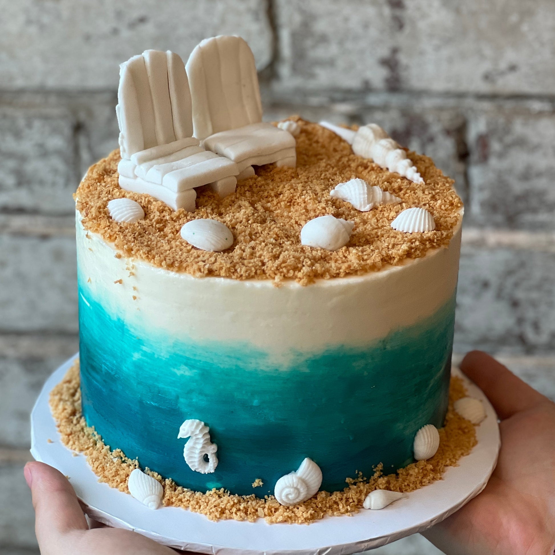 Beach-themed cake with two chairs
