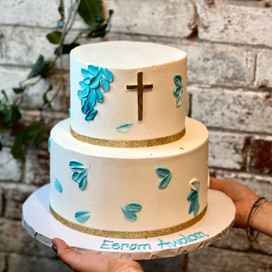 Two-tiered religious cake with cross