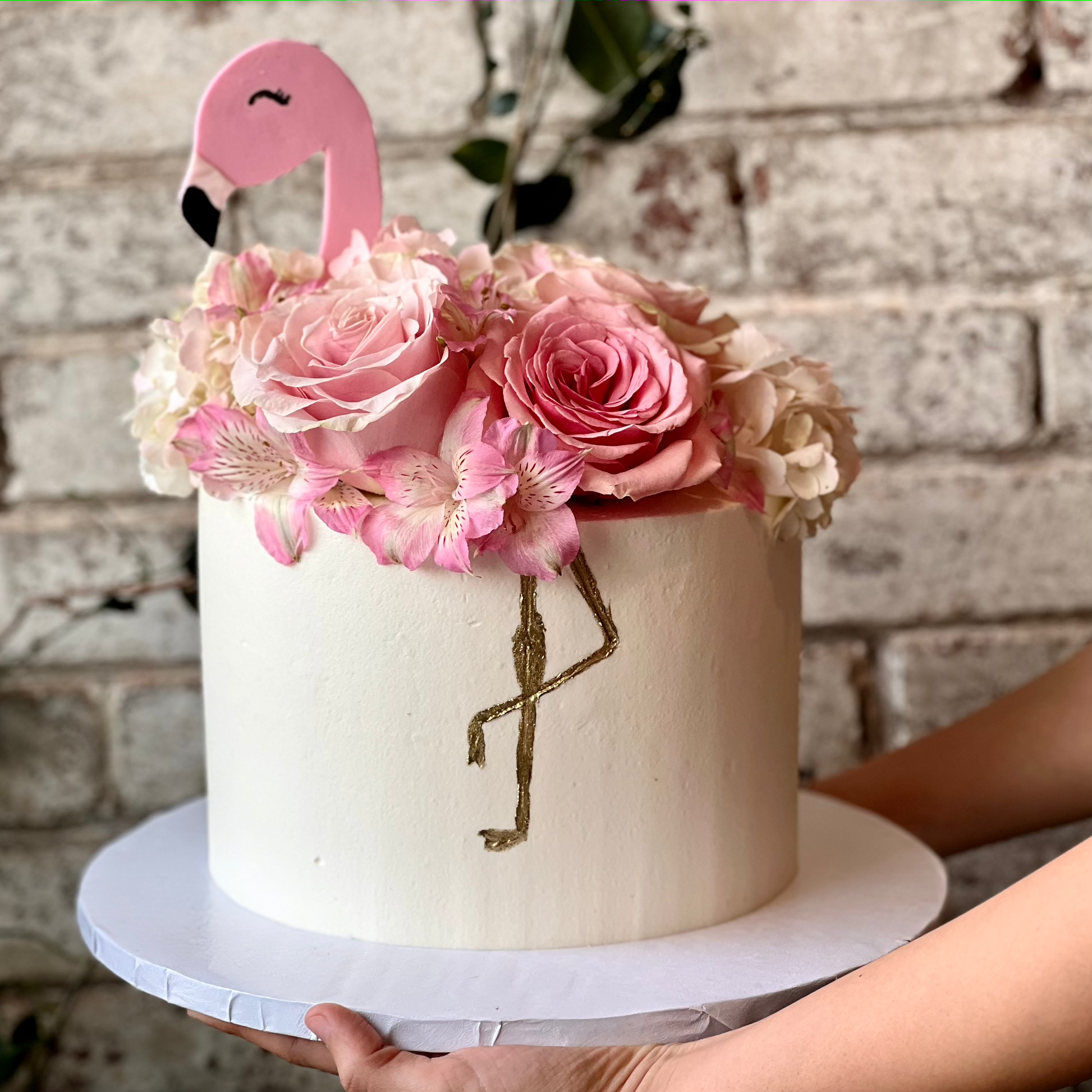Flamingo themed cake with pink fresh flowers