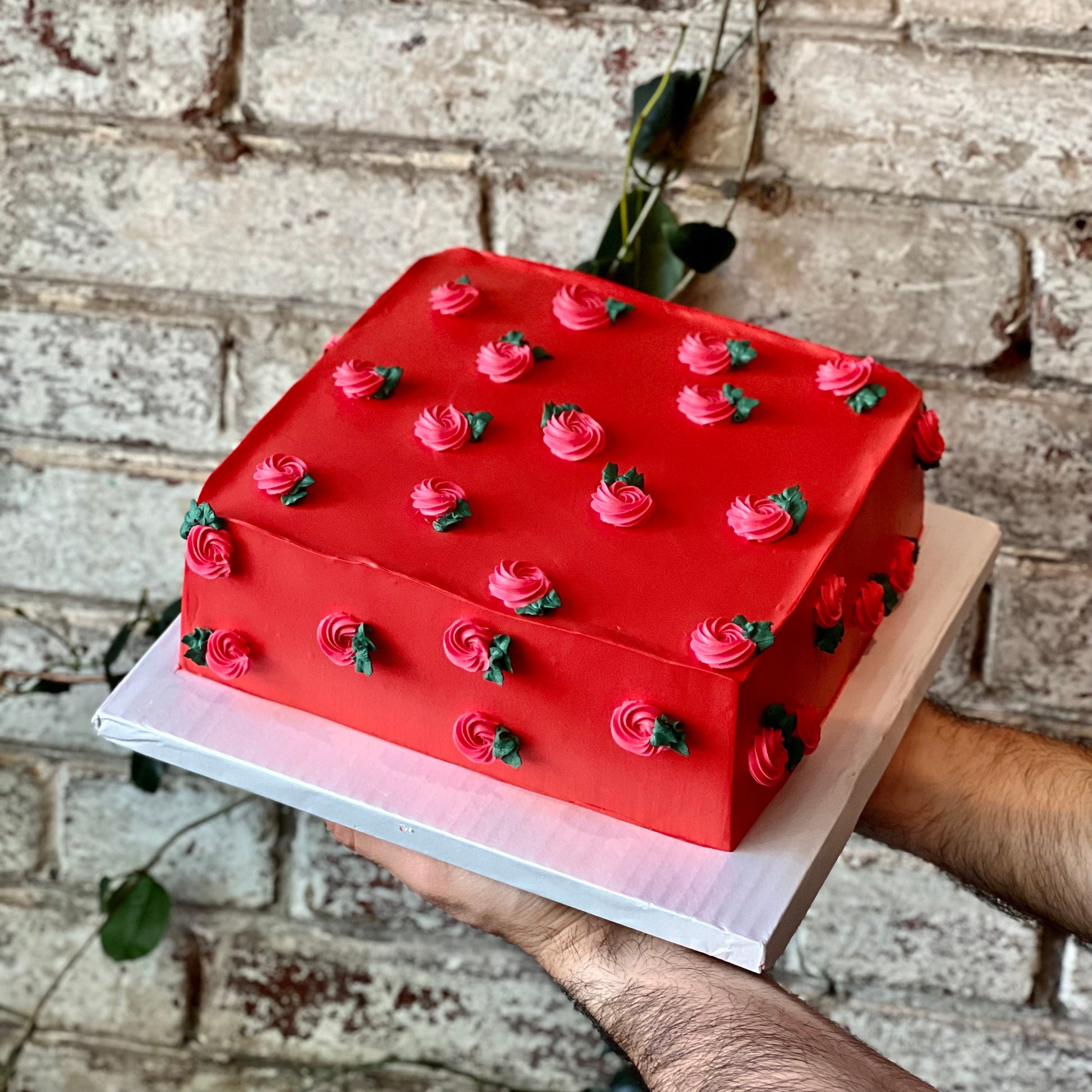 Square red cake with rosettes