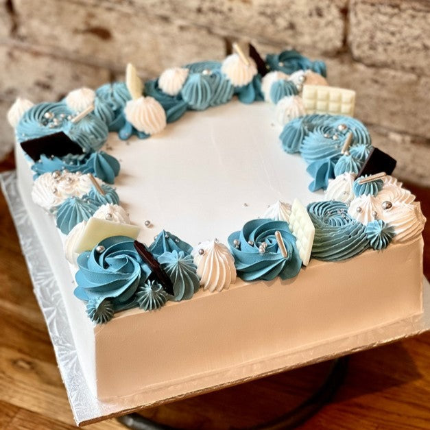 Square white sfoglia cake with blue design