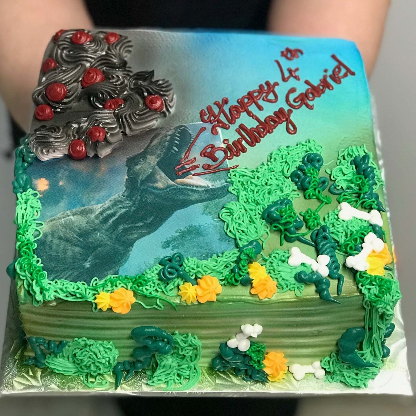 Dinosaur themed birthday cake with T Rex