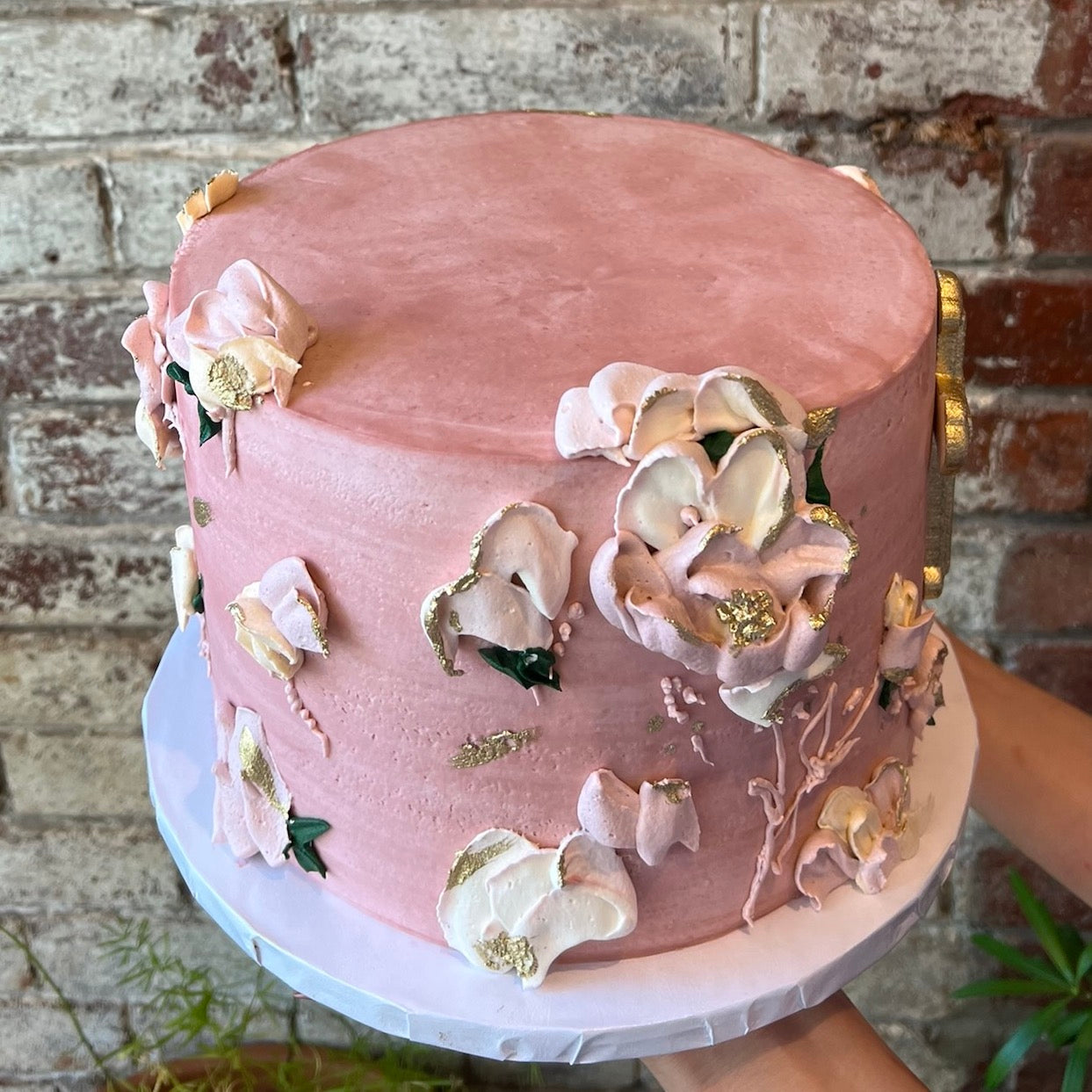 Pink cake with sculpted icing flowers