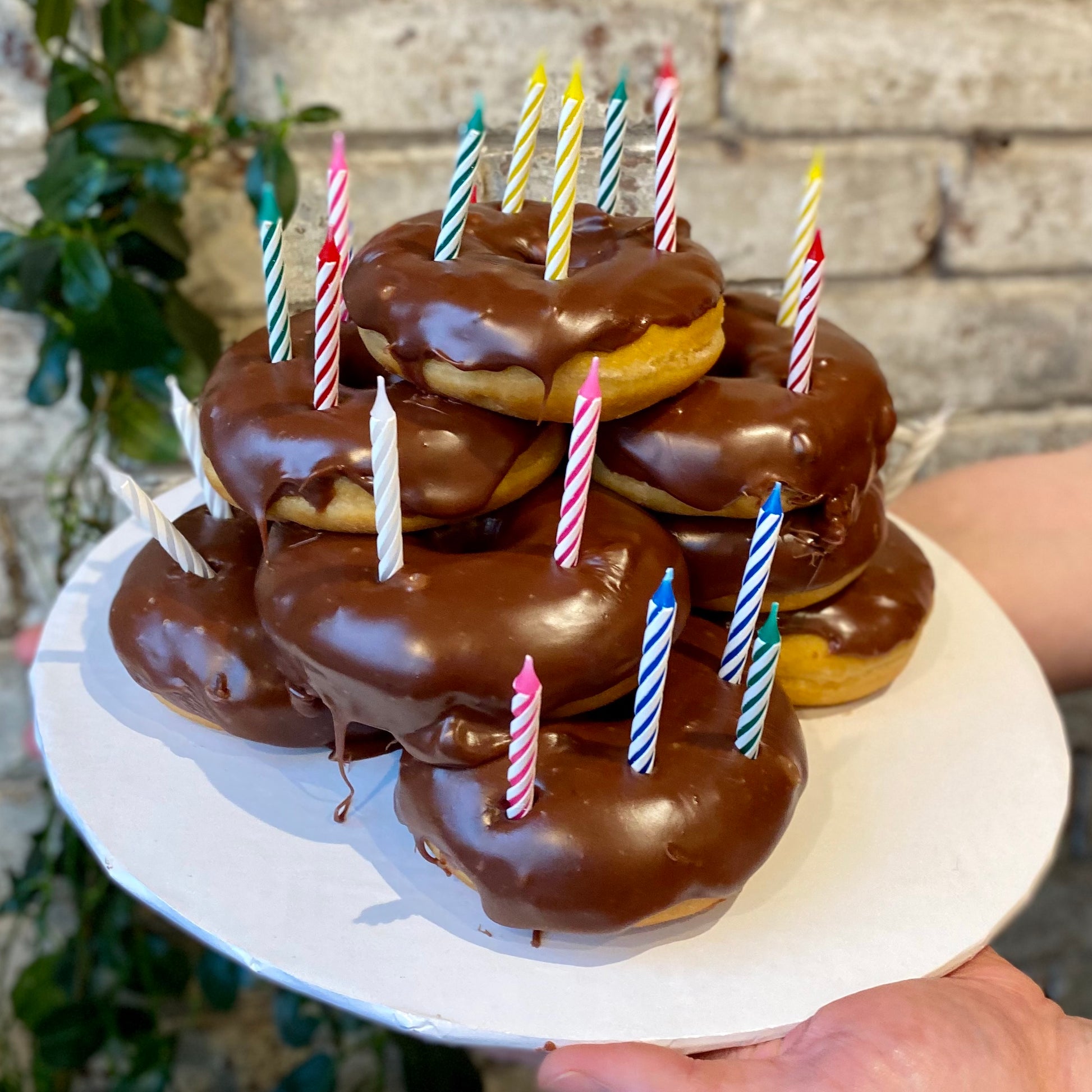 Pile of donuts with candles on top