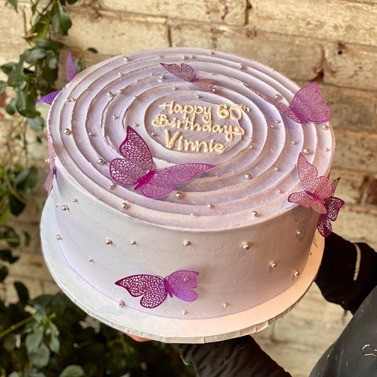 Pink cake with decorative butterflies