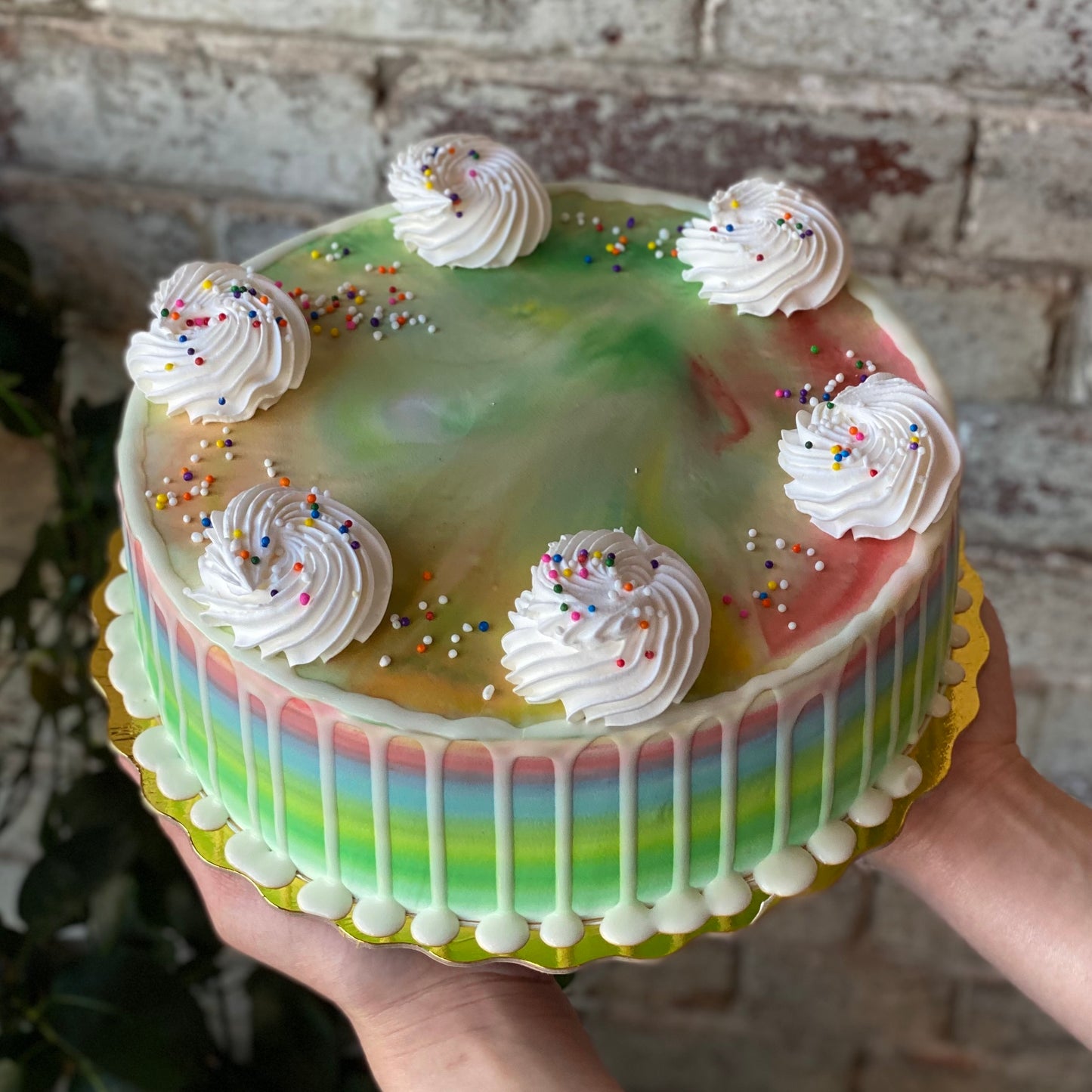 Colourful cake with white dollops