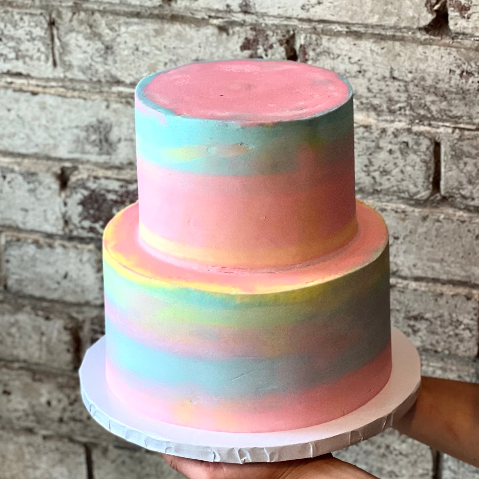 Two-tiered pastel coloured cake