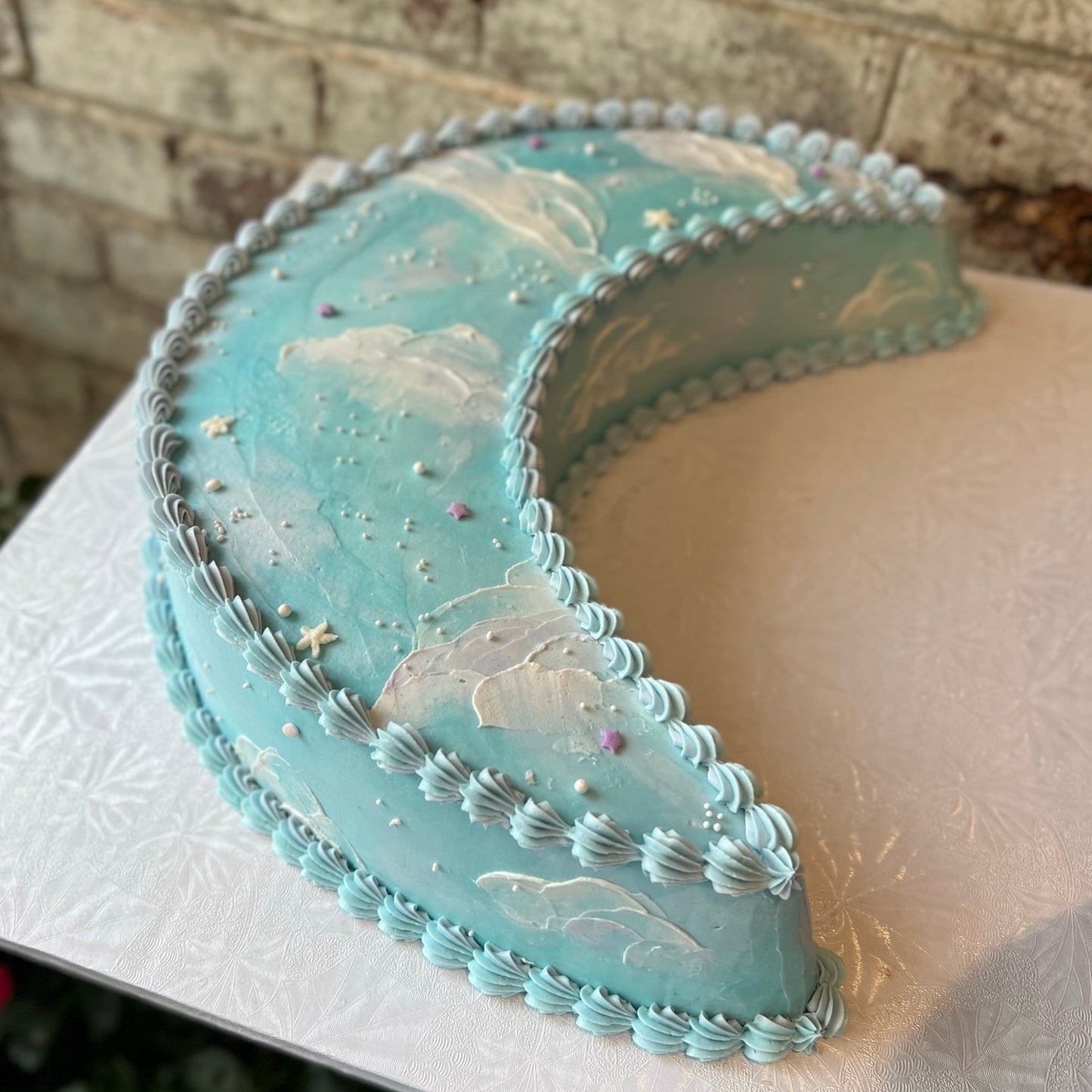 Light blue crescent moon shaped cake