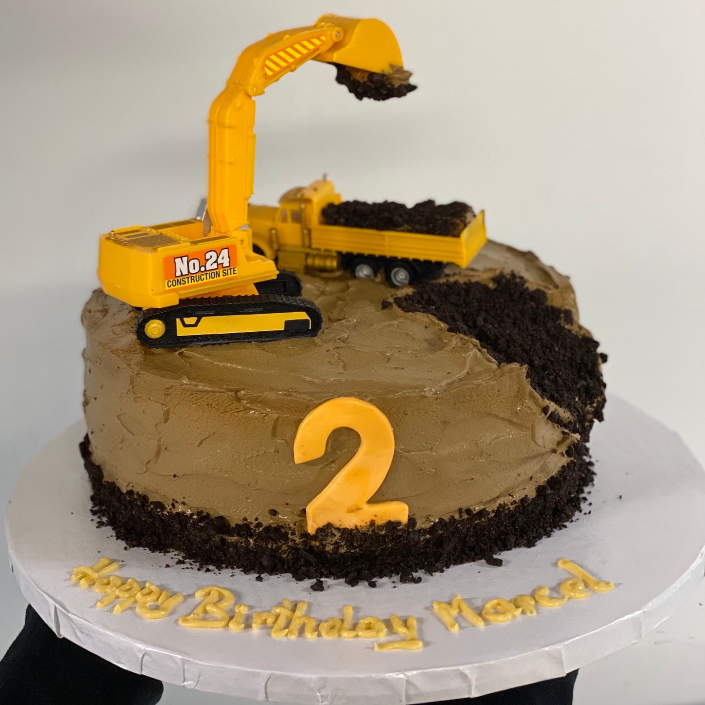 Chocolate construction themed cake for child's birthday with excavator on top
