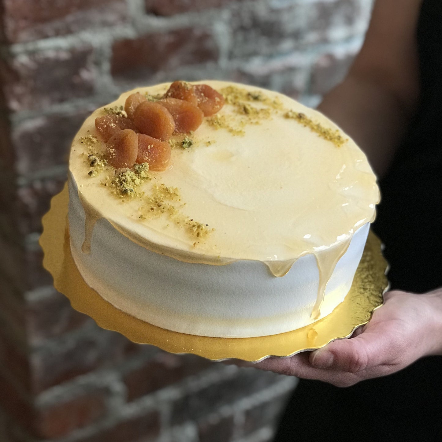 Pistachio and limoncello cream cake with dried apricots on top