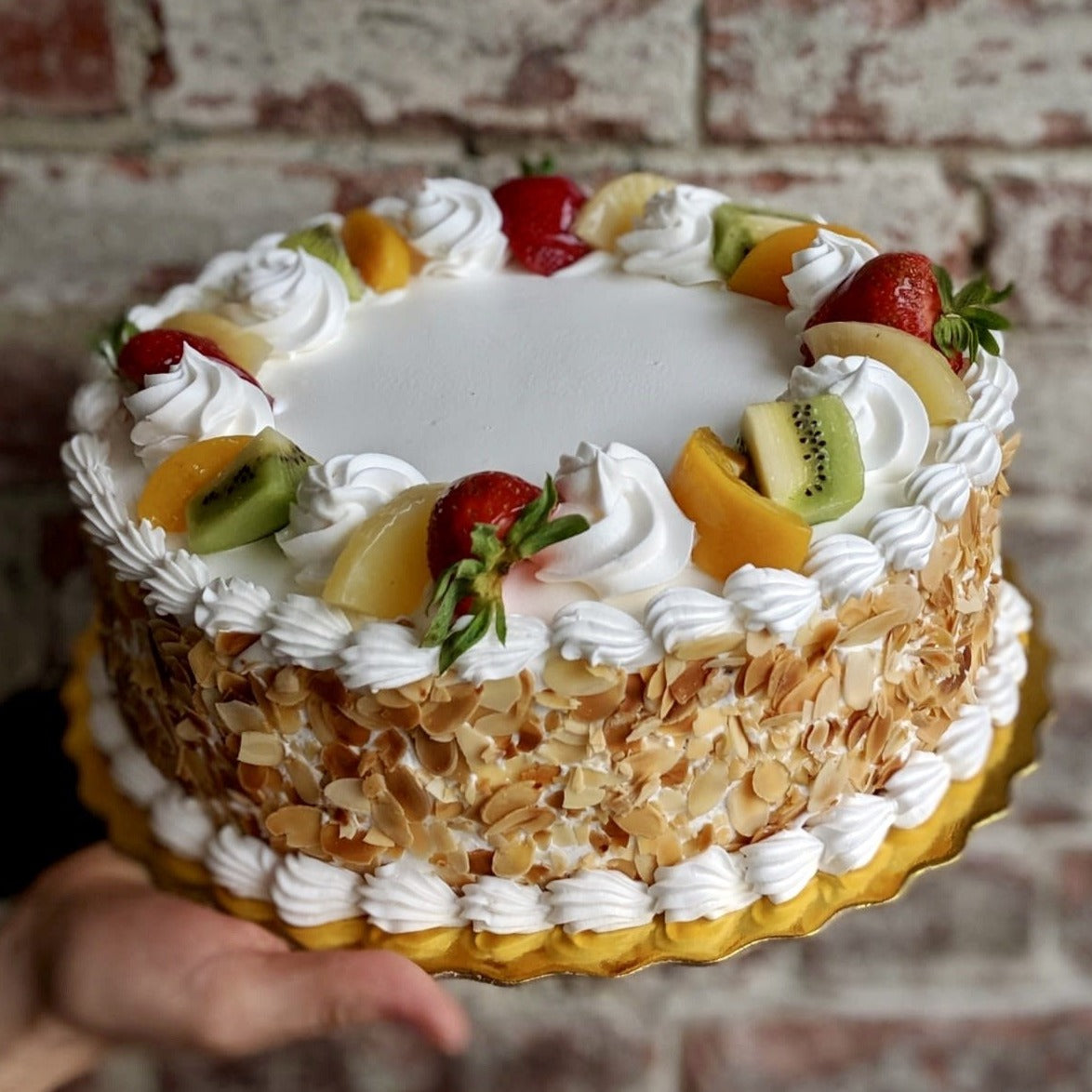 Tutta frutta cake with fresh fruit on top
