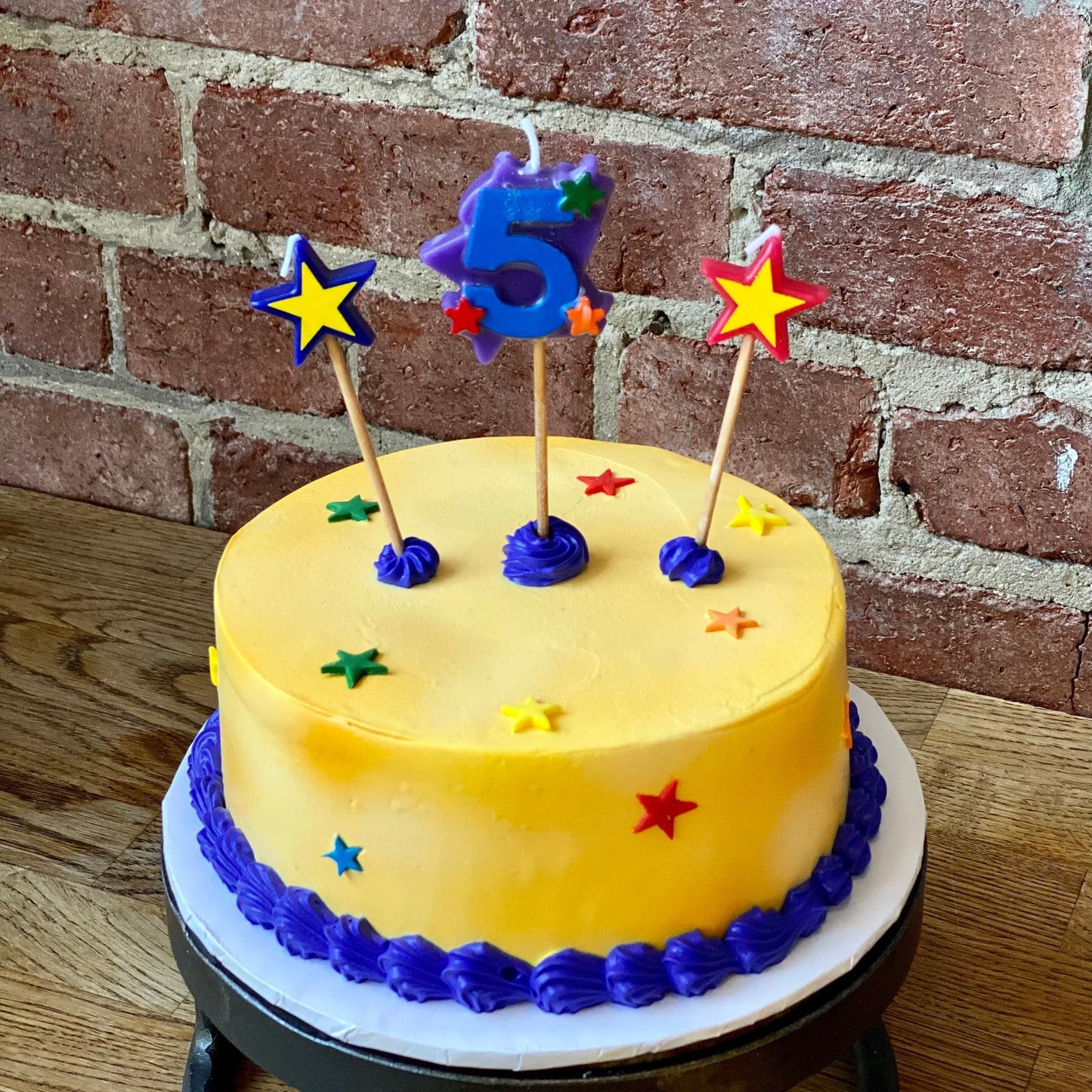 Kids birthday cake with a candle of the number five