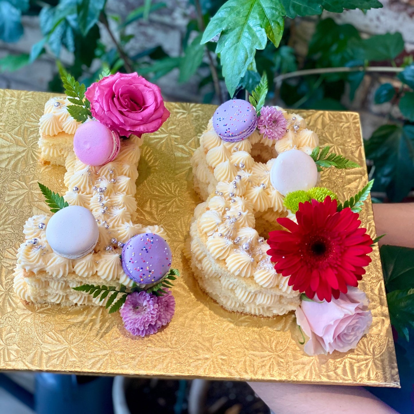 Cakes shaped as the number 18 with macarons and fresh flowers