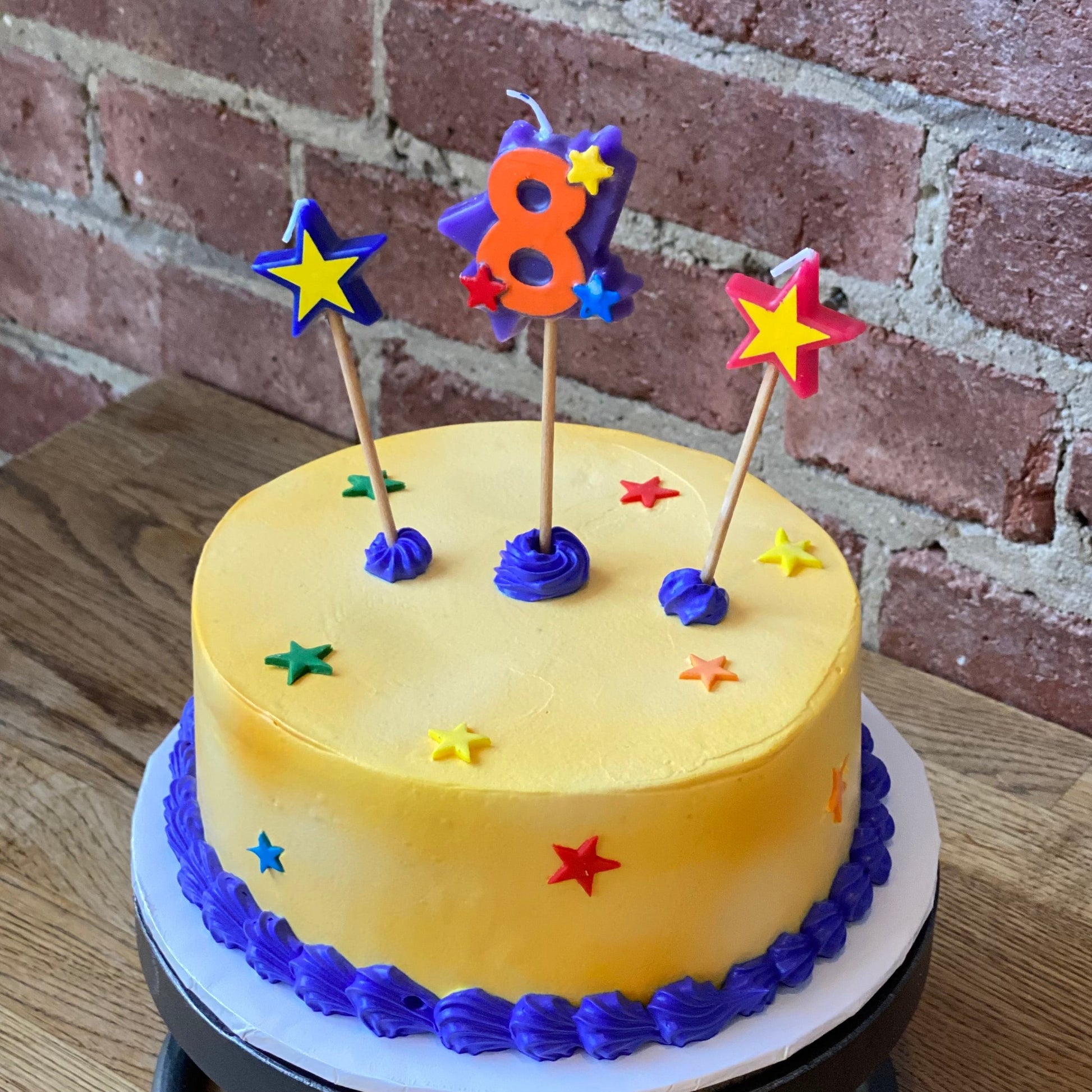 Kids birthday cake with a candle of the number eight