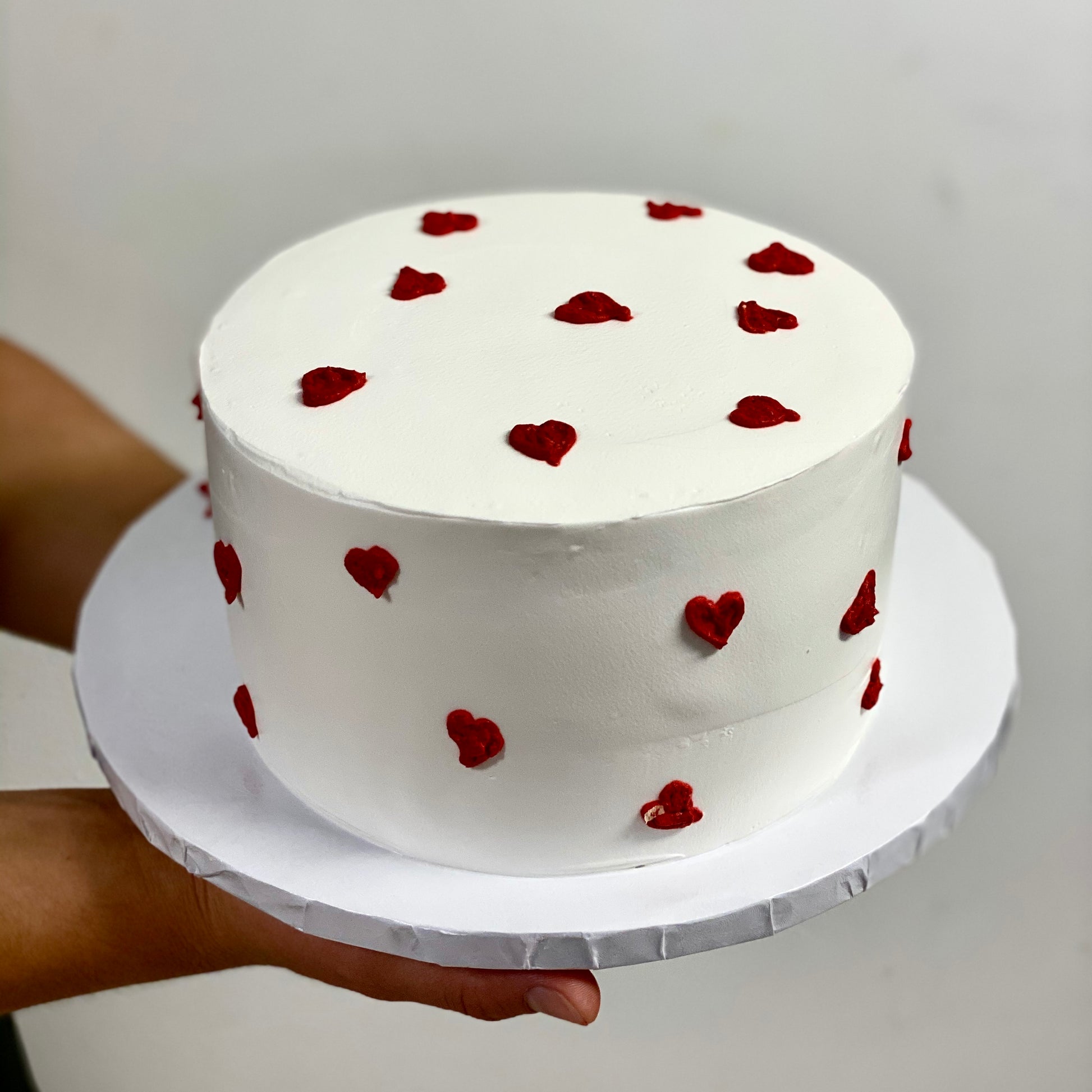 White cake with tiny red hearts