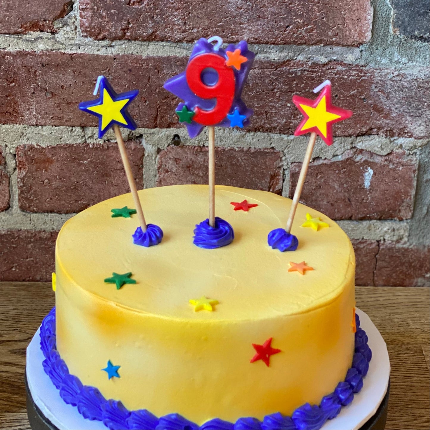 Kids birthday cake with a candle of the number nine