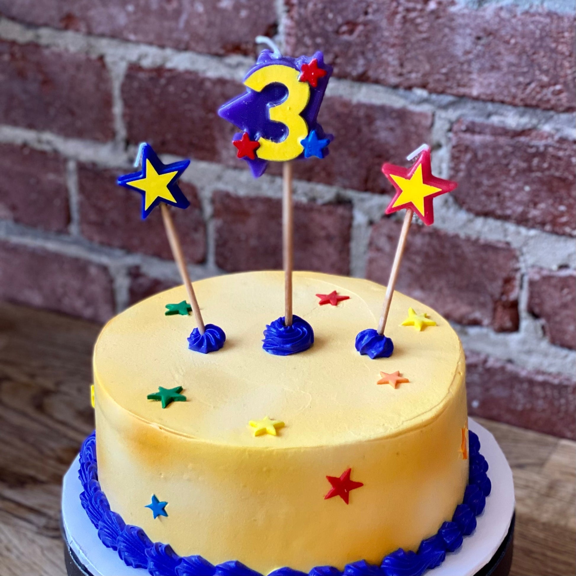 Kids birthday cake with candle of the number three