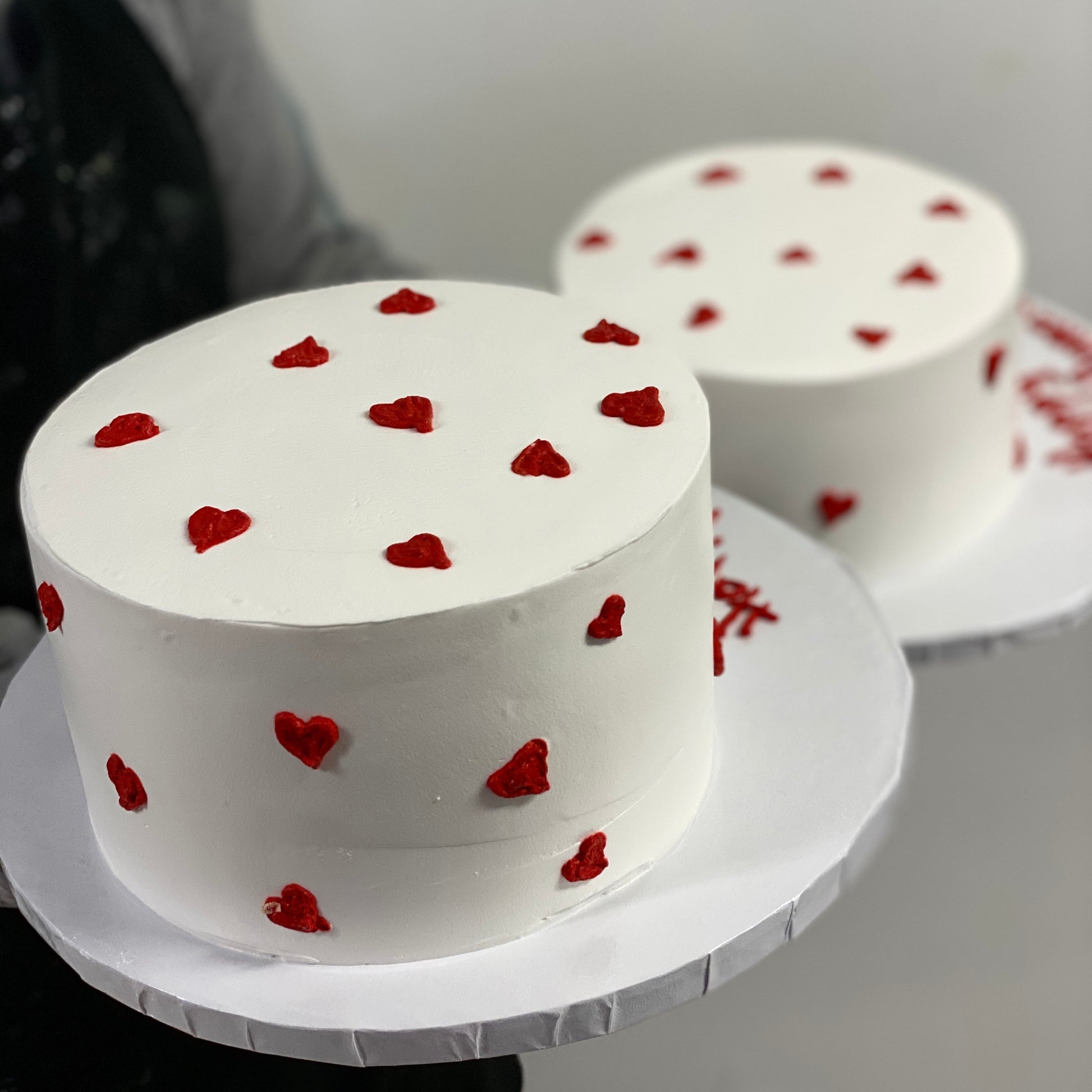 White cake with tiny red hearts