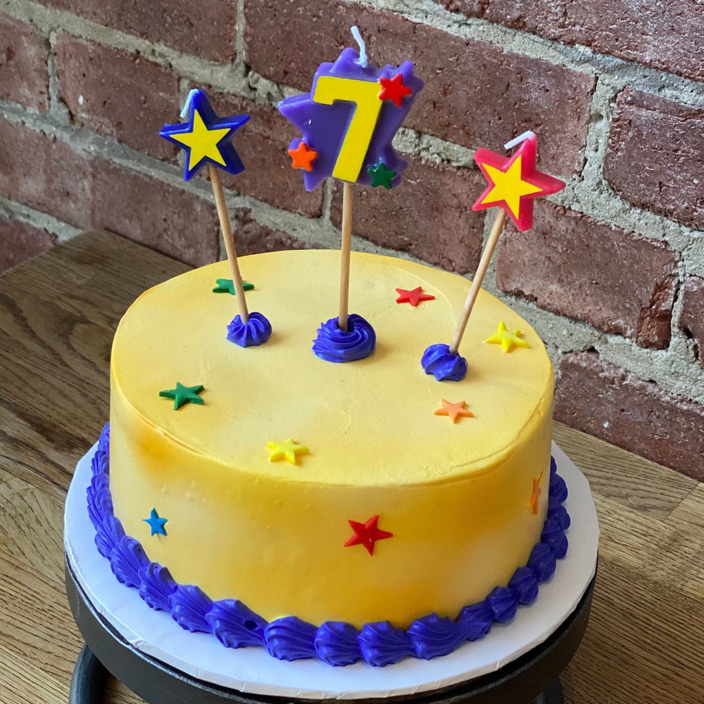 Kids birthday cake with a candle of the number seven