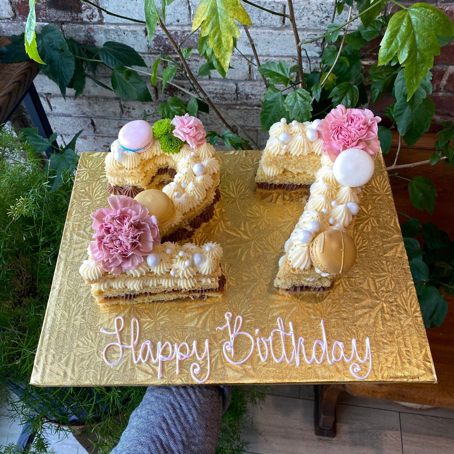 Cakes shaped as the number 27 with macarons and fresh flowers