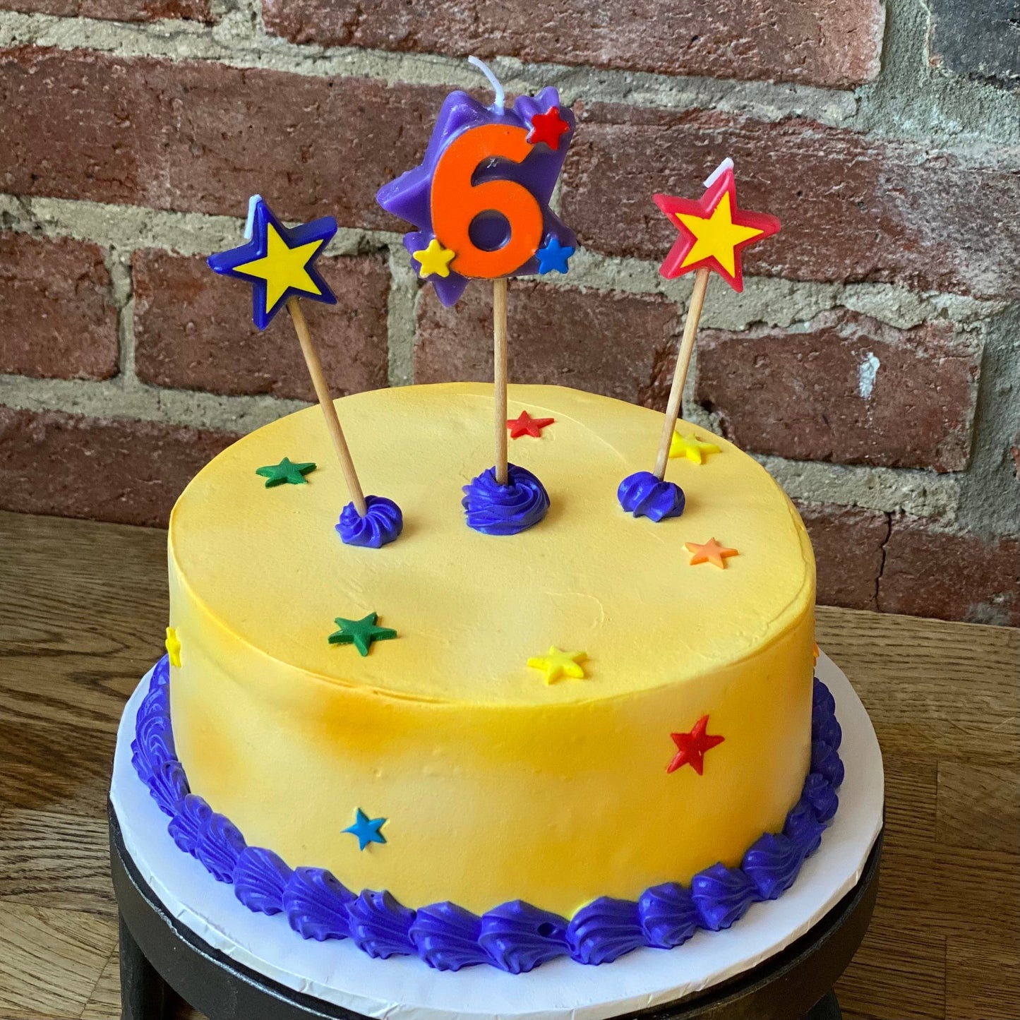 Kids birthday cake with a candle of the number six