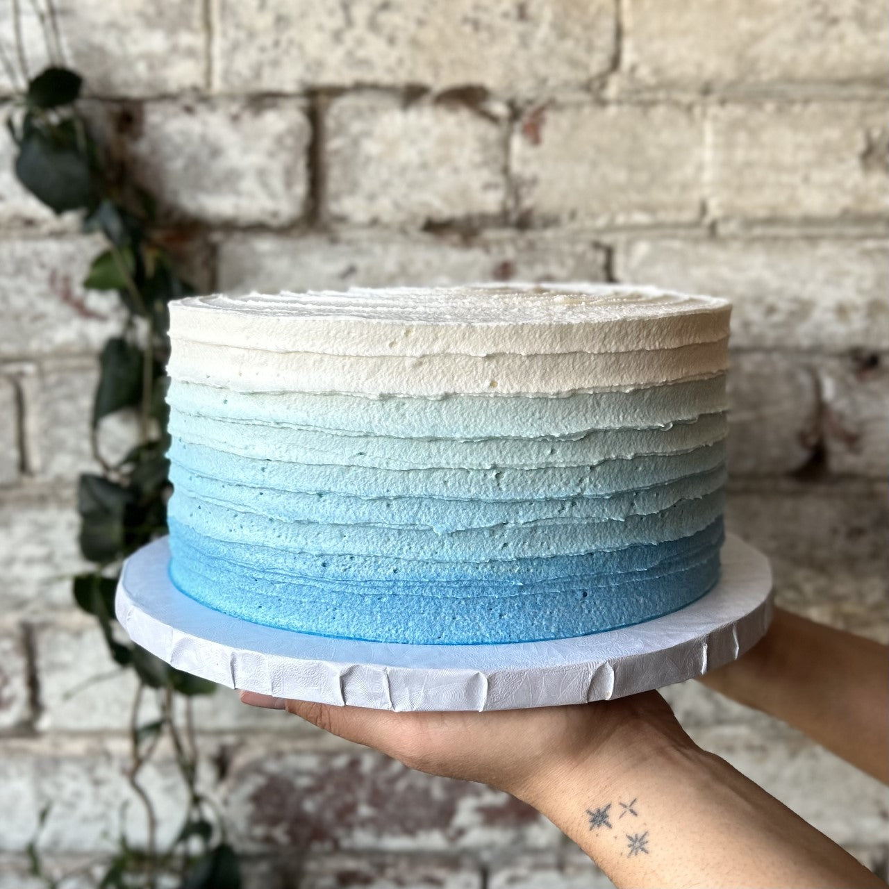 Rustic cake with light blue to white ombre